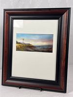 Front view showing framed lighthouse print with mat