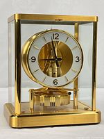 Front view of Atmos clock showing full brass and glass case