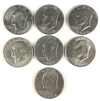 Obverse of seven Eisenhower dollars showing dates and condition