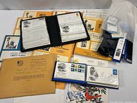 Overview showing FDC albums, Liberty Album supplements, plate-block envelope, mounts