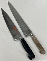 Both chef knives side by side displaying full length and handles