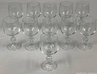 Group shot showing all eleven matching wine glasses
