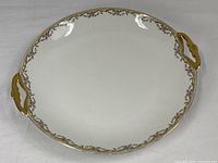 Full view of Limoges round platter showing floral border and handles