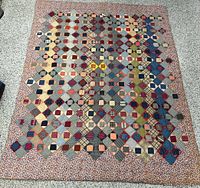 Full view of patchwork quilt showing overall design and border