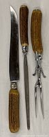 Full view of knife, steel and fork showing handles and blades