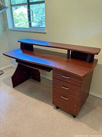 Front angled view showing entire desk with hutch, drawers, keyboard tray