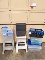 Front view of stacked storage bins, crate and step stools