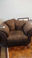 Front view of brown ultrasuede armchair showing overall design and upholstery