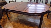 Full view of dining table with one leaf inserted