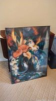 Full view of framed floral print leaning against wall