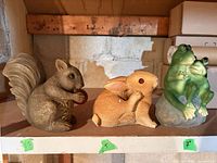 All three resin garden figurines on shelf
