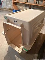 Angled view of crate showing open front, brand badge, and overall construction