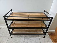 Front view of three-tier wood slat, metal frame shoe rack