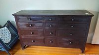 Front view showing 12 drawers, knobs, overall finish