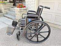 Left side profile of Medline wheelchair showing frame, wheels, armrests, footrests