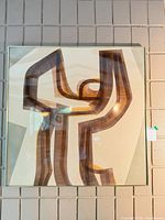 Full view of framed abstract print on wall