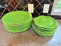 Stacks of green dinner and salad plates