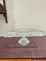 Side profile of crystal square cake stand on pedestal