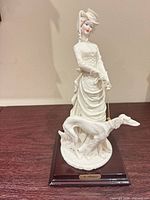 Front view of figurine on wooden base