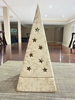 Front view of ceramic pyramid candle holder with star cut-outs