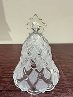 front view of pressed glass bell showing diamond lattice pattern and star finial