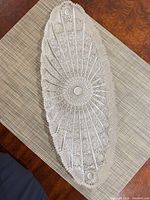 Top view of oval cut glass platter on placemat
