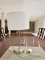 Full lamp on table showing base, stem, shade, pull chain, cord