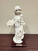 Front view of Giuseppe Armani porcelain figurine on wood base