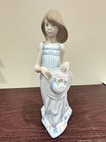 Front view showing full figurine and detailing on hat and dress