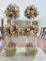 Front view of both gold & silver topiaries on table