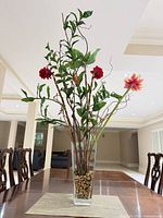 Full view of tall artificial floral arrangement on table
