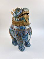 Three-quarter left view of cloisonné foo lion incense burner