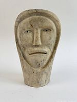 Front view showing facial carving and overall form