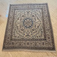Full view of square Persian Nain rug showing overall pattern and colours