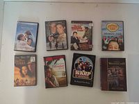 Eight DVD cases laid out showing titles The Notebook, Onegin, Throw Momma From The Train, Corner Gas, Dirty Pretty Things, The Descendants, WKRP In Cincinnati, This Is Wonderland