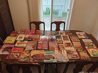 Tabletop view showing all 36 cookbooks arranged in rows