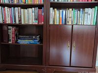 Bookcase showing two sections filled with mixed hardcover and softcover books