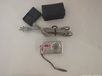 Casio Exilim camera, wrist strap, soft case, battery charger, AC cord