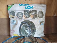 Front of COOL LOK storage bag with tire chain illustration and portion of blue-ring chains visible