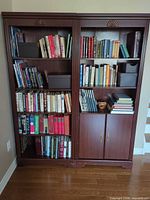 Both bookcase towers filled with books showing overall design and colour