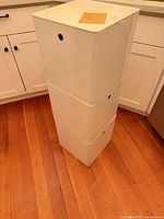 Three white plastic bins stacked together showing overall appearance