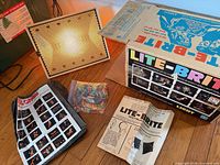 Lite-Brite panel lit, box, peg bag, instruction sheet, pattern booklet