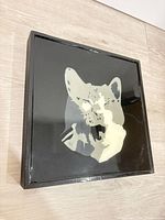 Overall view of square cat wall art on glossy black wood panel