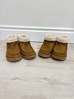 Front view two pairs of tan suede toddler boots