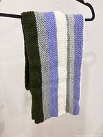 Blanket folded over hanger showing color stripes