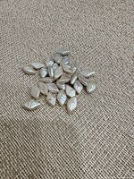 Group of marquise mother-of-pearl beads on fabric background