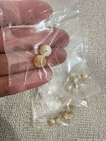 Close-up of two‐tone bead in bag and additional bagged beads
