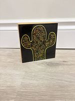 Front view of decorative box standing upright showing cactus design