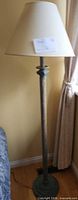 Full view of floor lamp showing height, base, column, patina, shade