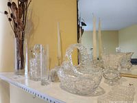 Group shot of crystal and glass items on mantel